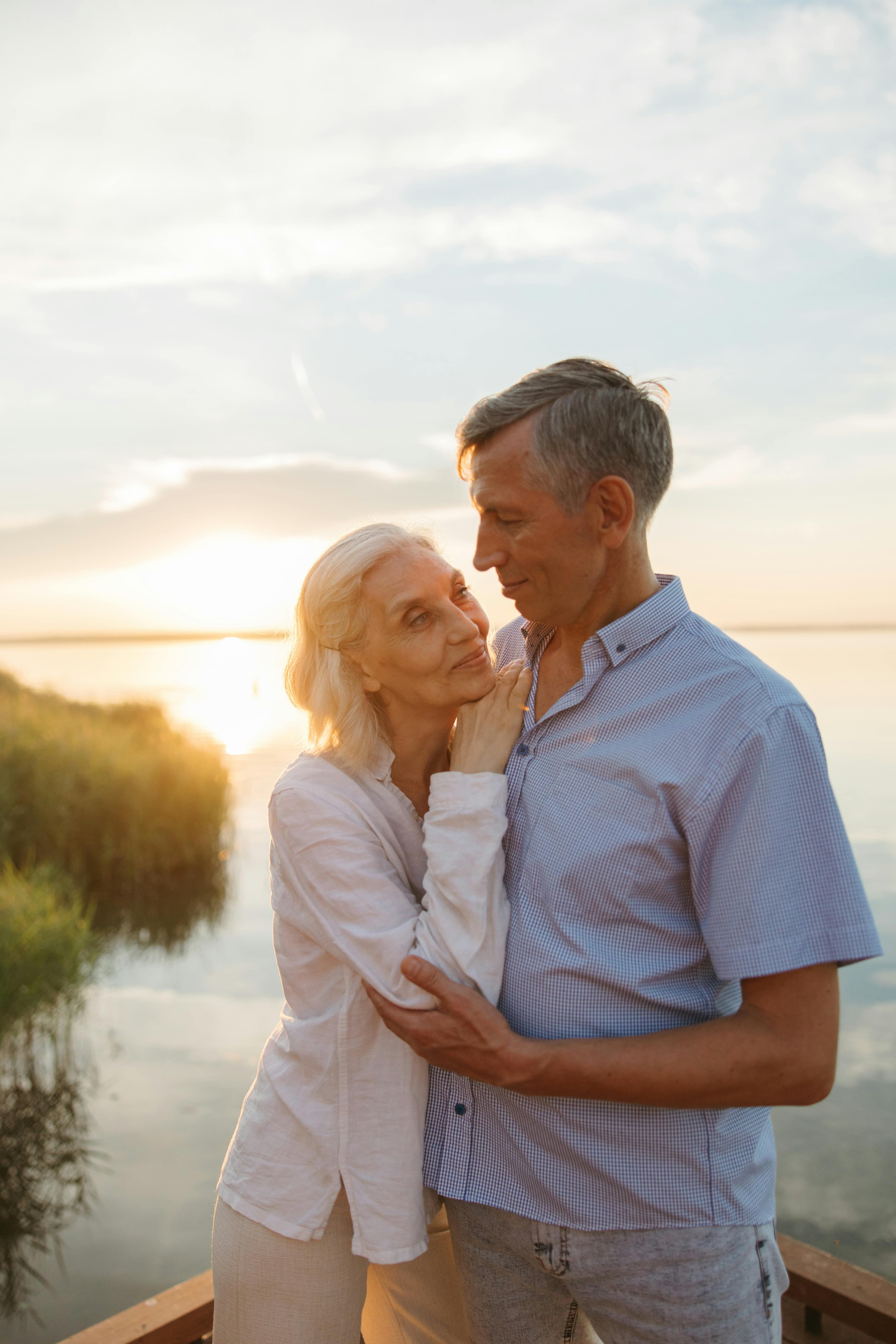 A couple together outdoors, the woman wearing a Memoura pendant
