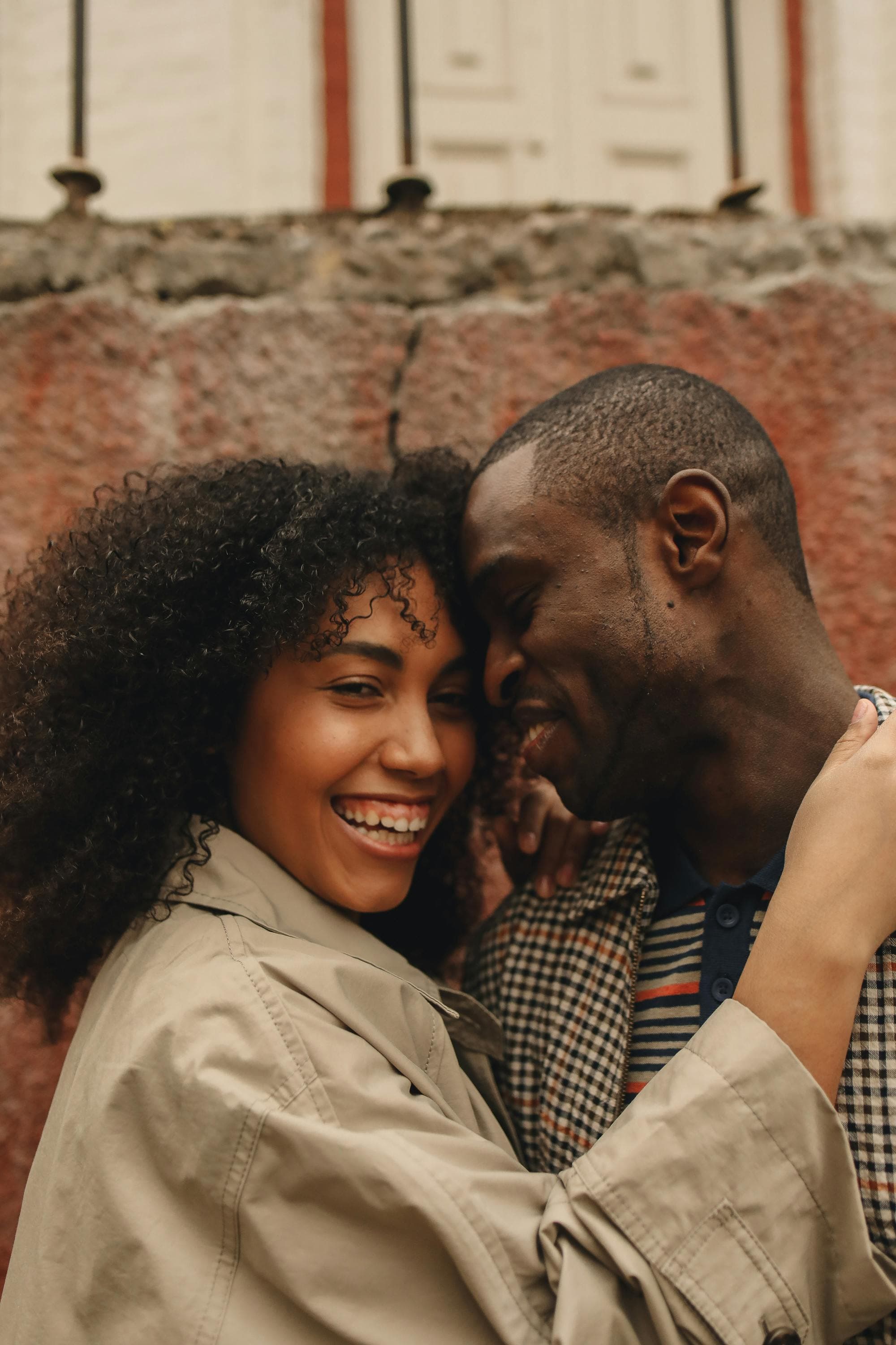 A young couple sharing a quiet moment, the woman wearing a Memoura pendant